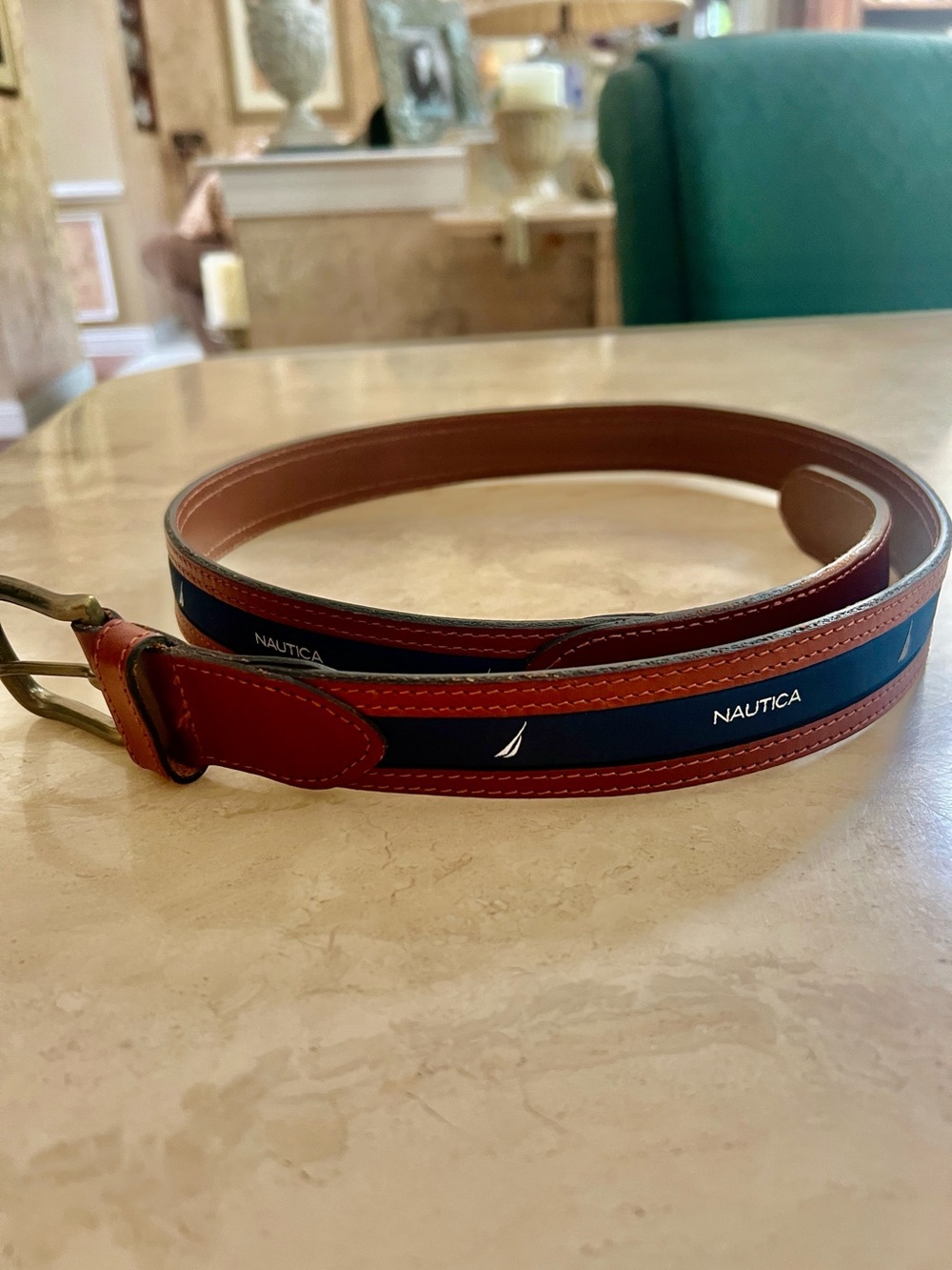 Nautica men's belt featuring brown leather,blue canvas inlay, brass buckle